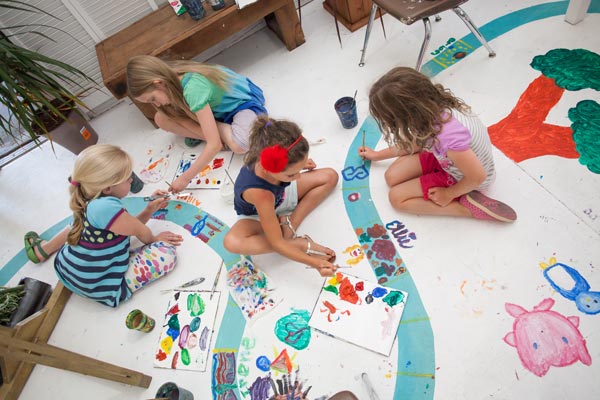 Fun-at-exhibit Kids creating floor art at Marvegos exhibit